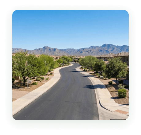 A curved residential street below the mountains in Anthem, Arizona